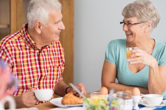 senior couple eating breakfast together