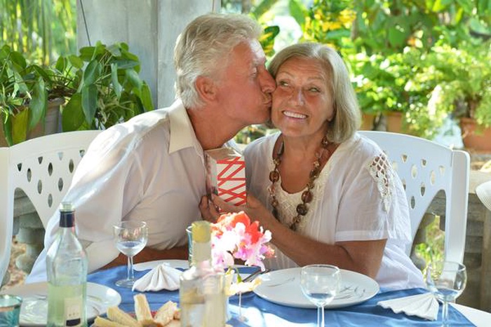 happy mature couple eating dinner restaurant