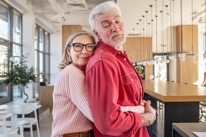 Medium shot smiley woman holding man