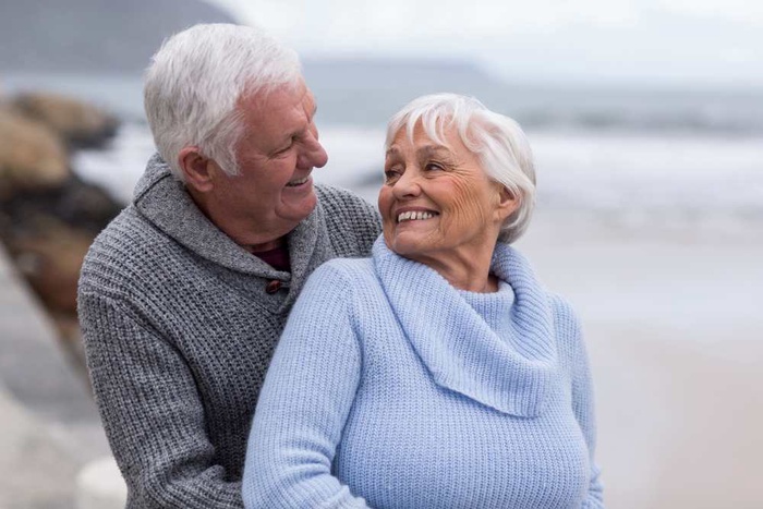 Senior couple embracing each other on the beach