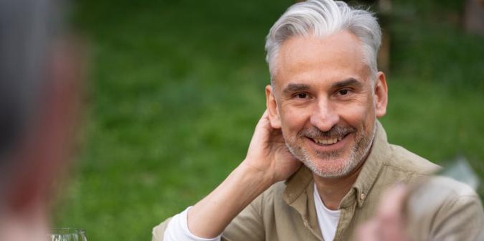 Smiling senior man outdoors ready for love again