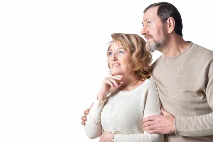  Smiling couple senior standing on white background