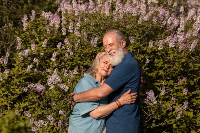 Medium shot happy couple hugging