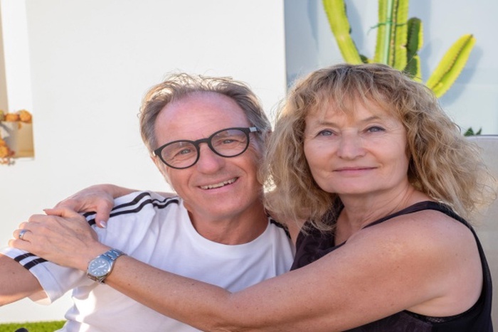 Portrait of handsome middle aged couple embracingexchanging cuddles enjoying moment of affection