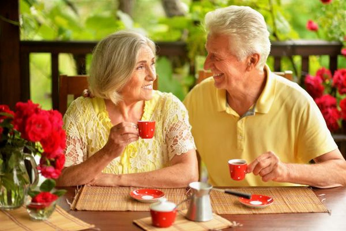 Happy senior couple drinking coffee