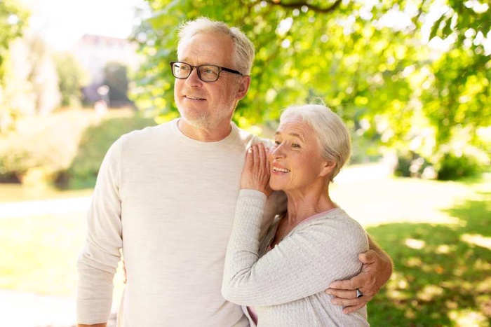 old age love and people concept happy senior couple hugging at summer park