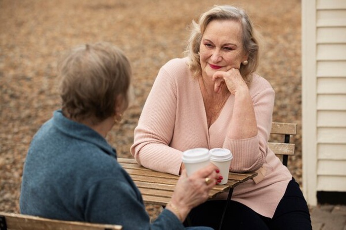 senior friends sitting at table