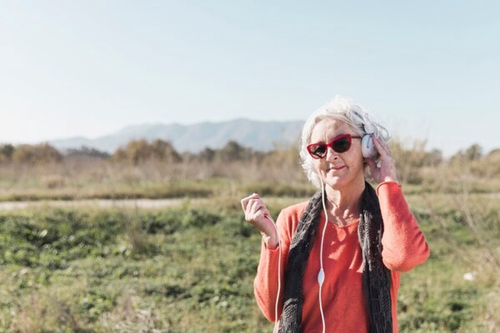 senior woman with headphones outdoors
