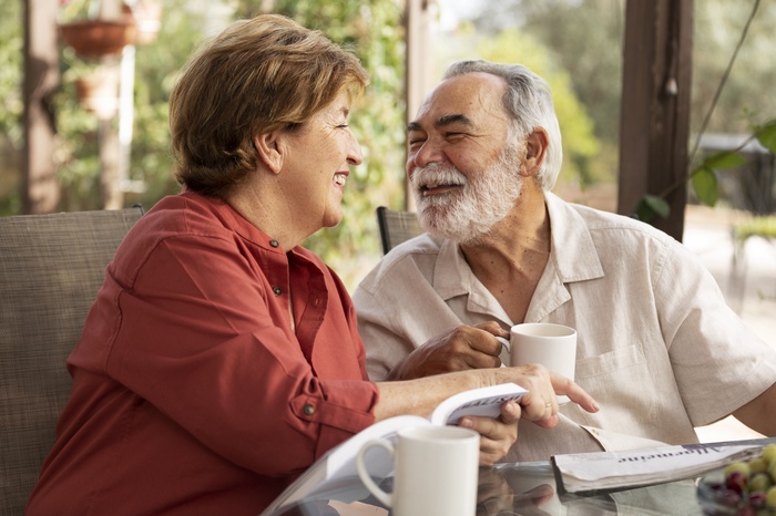 Elderly couple reading together at their countryside home