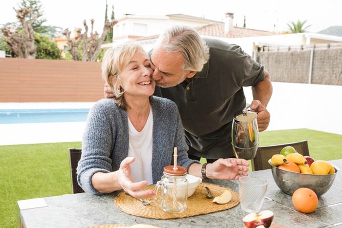 Senior couple having breakfast in garden