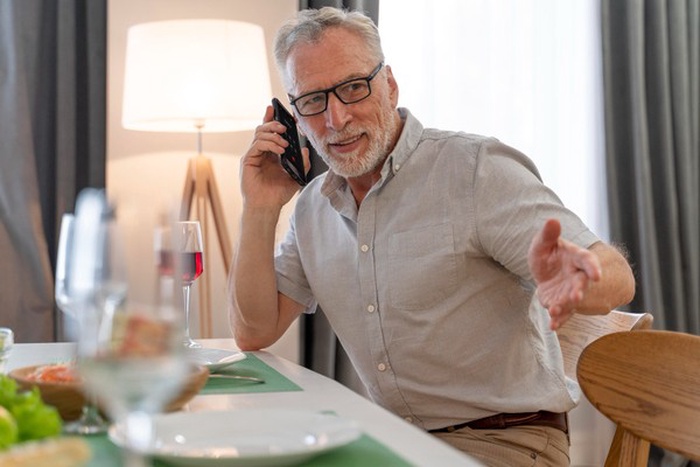 mature man preparing dinner for family