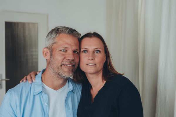  A happy couple is having fun at home while sitting on the floor