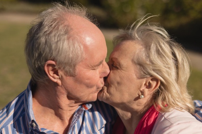Senior couple kissing each other in the park