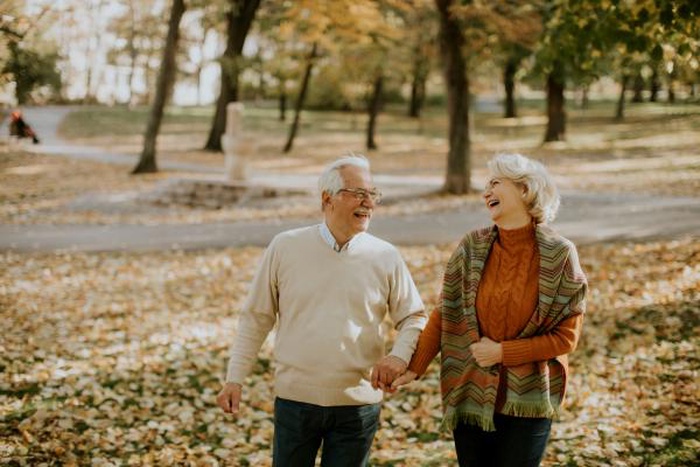 senior couple walking in autumn park