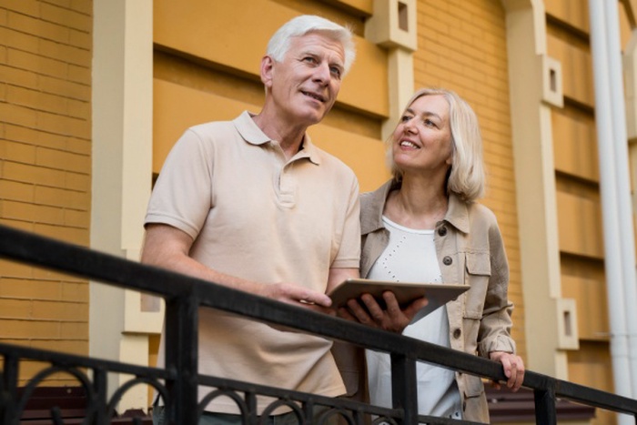  Senior couple out in the city with tablet