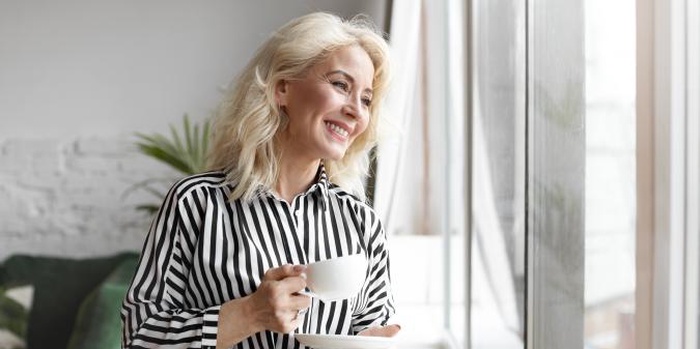 Senior woman looking hopeful smiling outdoors