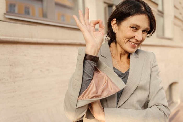 Happy caucasian adult brunette woman smiles