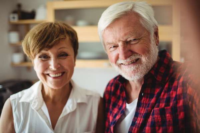  Senior couple smiling in kitchen