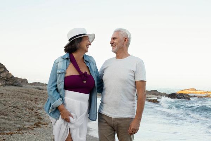 senior loving couple spending time together beach