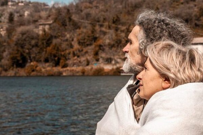 senior couple kissing in water