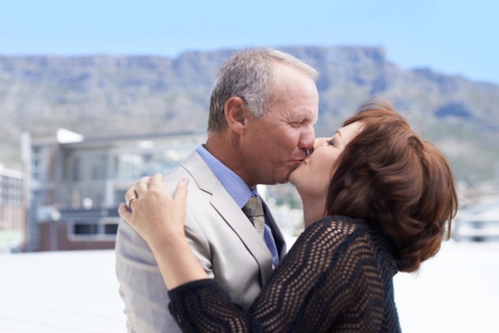 Love hug and kiss with mature couple in real estate agency for partnership consultants and entrepreneur venture smile teamwork and collaboration with senior man and woman in startup company