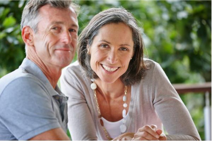 Smiling mature couple relaxing outside