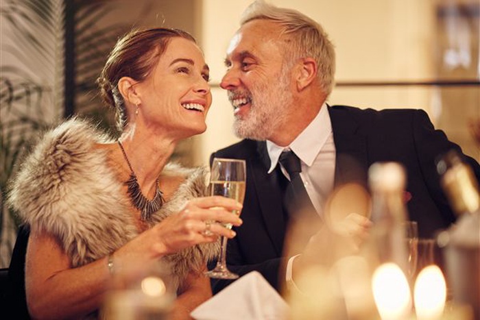 Sunset Beach couple sharing a relaxed dinner after 50