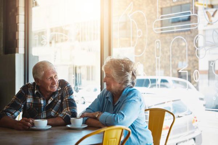 A senior couple chatting in a café