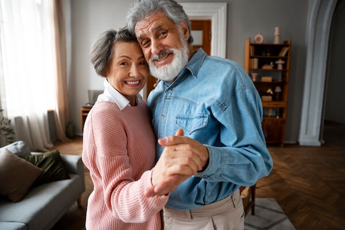 old couple dancing at home