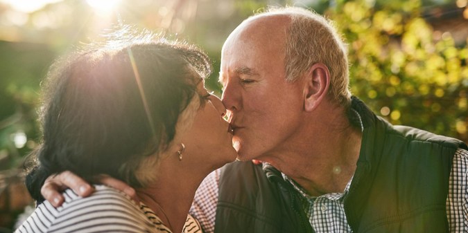 Kiss love and senior couple in nature for love date