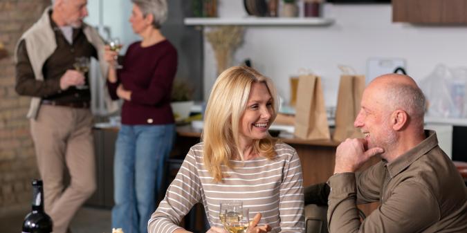 Mature singles talking at a social gathering