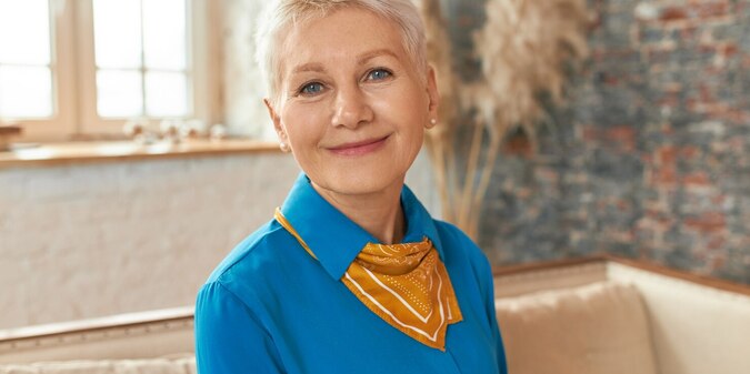beautiful middle aged woman wearing blue shirt