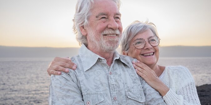 senior couple embracing on the beach