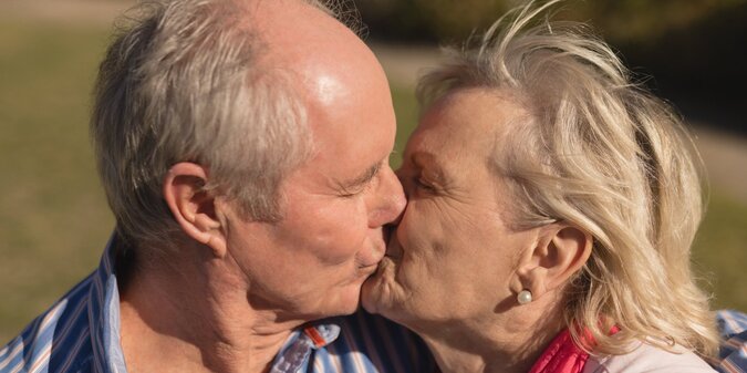 Senior couple kissing each other in the park