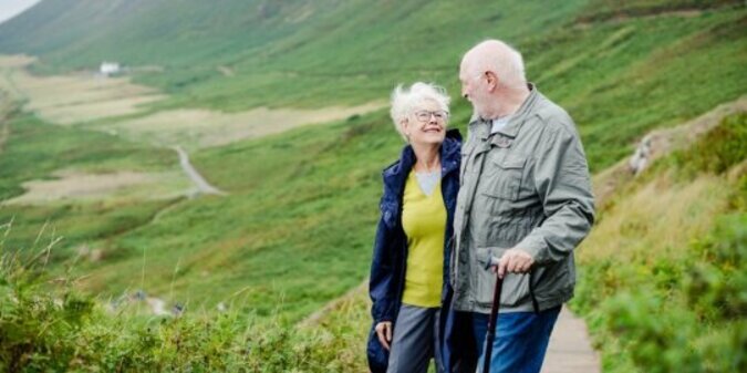 Happy romantic seniors strolling together