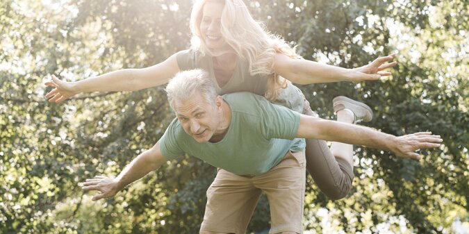 Elderly couple fooling around in the park
