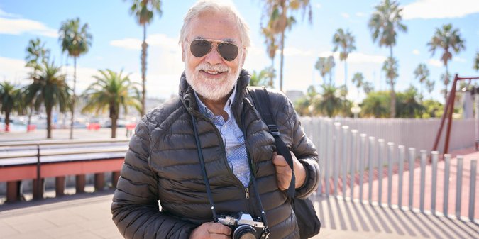Portrait of caucasian mature man tourist with beard