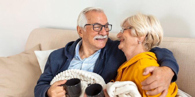 Happy old couple sitting on the sofa