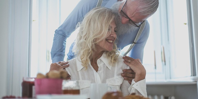 senior woman eating food on table