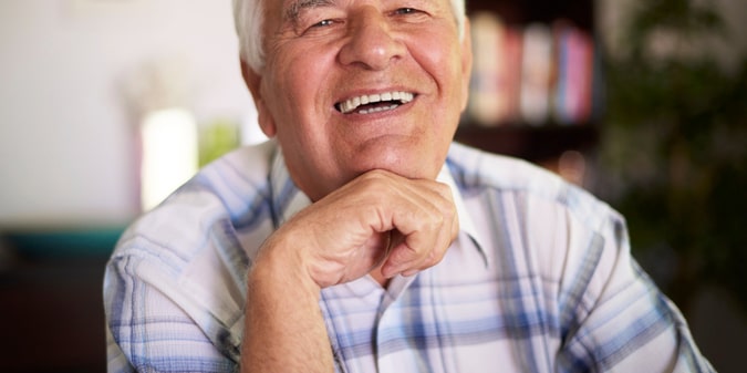 Portrait of cheerful grandfather in the sitting room