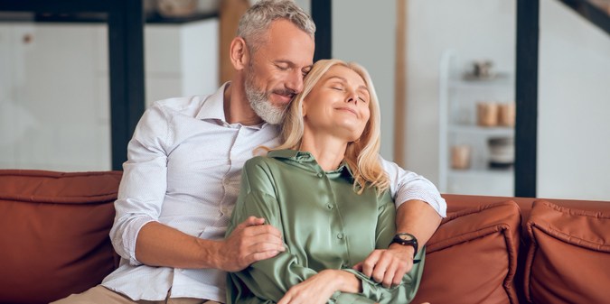 Mature couple sitting on the sofa and feeling peaceful