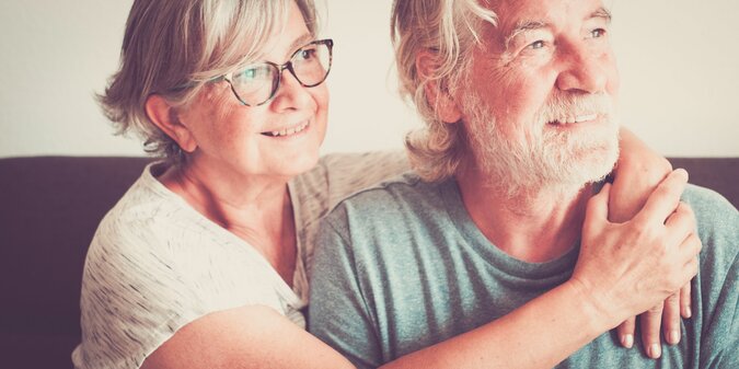 smiling senior couple sitting at home