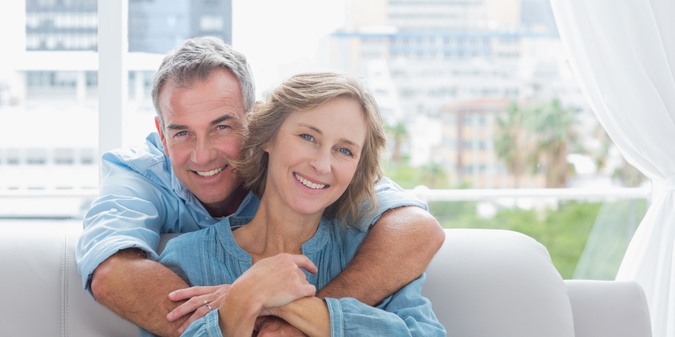 Content man hugging his wife on the couch