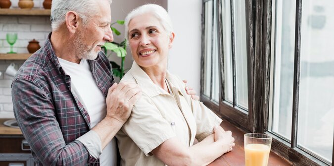 Elder couple looking through the window