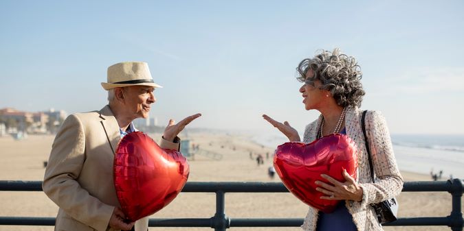 couple sending air kisses to each other