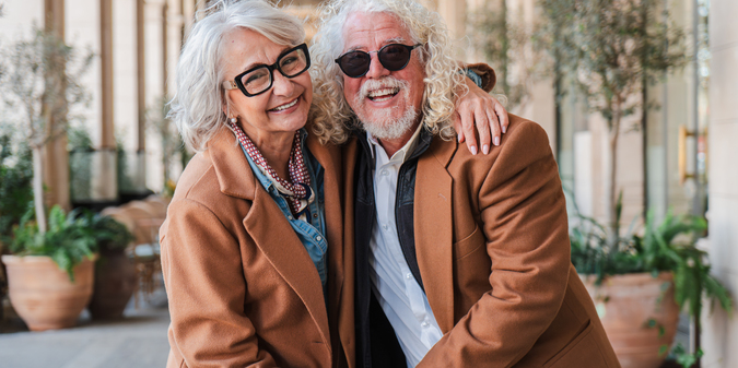 joyful seniors while holding hands sharing laughter warm