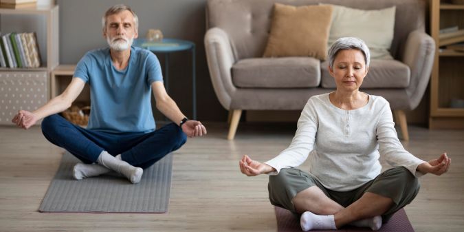 Senior over 50 practicing mindful meditation for stress relief and mental clarity in a calm environment.