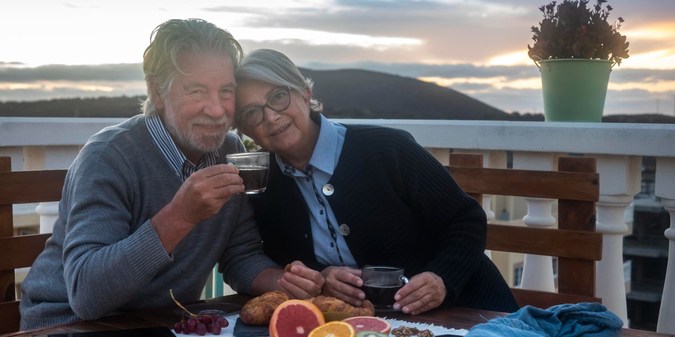 Man and woman sitting on table