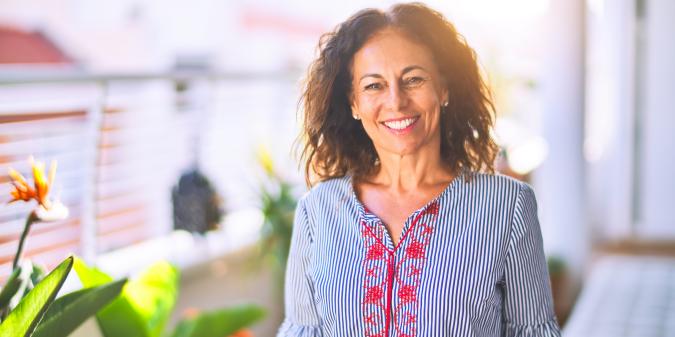 Confident attractive woman smiling over 50
