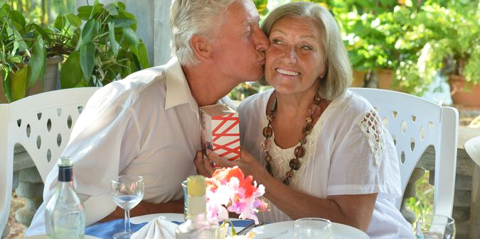 Happy mature couple eating dinner at restauran